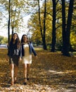 Mature real mother with daughter outside autumn fall in park