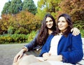 Mature real mother with teenage daughter outside autumn fall in park, lifestyle happy smiling people concept