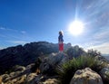 Mature redhead woman backlight with wind-blown hair on the mountain Cim Penya Roja, Els Poblets, Alicante, Spain Royalty Free Stock Photo