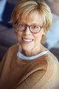 Mature, relax or portrait of happy woman in glasses in house living room with freedom, pride for resting break