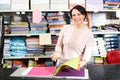 Mature saleswoman offers various fabrics types