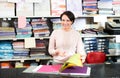 Mature saleswoman offers various fabrics types