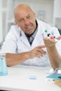 Mature scientist making research over dna molecule structure Royalty Free Stock Photo