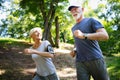 Mature or senior couple doing sport outdoors, jogging in a park Royalty Free Stock Photo
