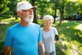 Mature or senior couple doing sport outdoors, jogging in a park Royalty Free Stock Photo