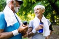 Mature or senior couple doing sport outdoors, jogging in a park Royalty Free Stock Photo