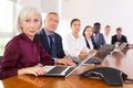 Mature senior white businesswoman listening to presentation Royalty Free Stock Photo