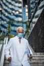 Mature serious doctor on street wearing protective mask Royalty Free Stock Photo