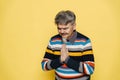 Mature serious man with grey beard making prayer gesture