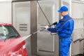 Serviceman With High Pressure Water Jet Washing Car Royalty Free Stock Photo