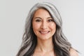 Mature shirtless woman with grey hair smiling and looking at camera Royalty Free Stock Photo