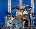 Mature silver haired drummer - action shot taken in Chippenham Park, Wiltshire, UK