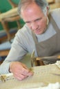 Mature skilled workman repairing chair