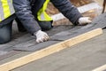 Workman install tile on roof of new house under construction Royalty Free Stock Photo