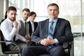 Mature smiling business manager in front of his business team Royalty Free Stock Photo