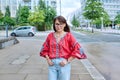 Mature smiling woman in embroidered shirt looking at camera, on street of modern city Royalty Free Stock Photo