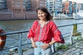 Mature smiling woman in embroidered shirt looking at camera, outdoor Royalty Free Stock Photo