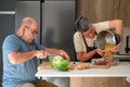 Mature Spanish couple cooking cocido, typical Spanish dish.