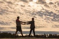 Mature sportive couple dancing in the sunset sun in nature Royalty Free Stock Photo