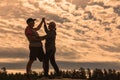 Mature sportive couple dancing in the sunset sun in nature Royalty Free Stock Photo