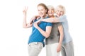 Mature sportswoman showing peace gesture while two senior sportswomen embracing her Royalty Free Stock Photo