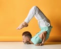 Mature sporty man practicing yoga in Vrischikasana scorpion asana Royalty Free Stock Photo