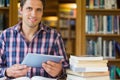 Mature student holding tablet PC in the library Royalty Free Stock Photo