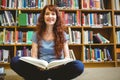 Mature student reading book in library Royalty Free Stock Photo