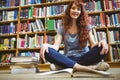 Mature student reading book in library Royalty Free Stock Photo