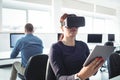 Mature student in virtual reality headset using digital tablet Royalty Free Stock Photo