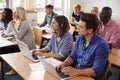 Mature Students Sitting At Desks In Adult Education Class Royalty Free Stock Photo