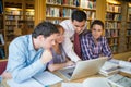 Mature students with teacher and laptop in library Royalty Free Stock Photo