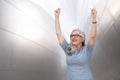 Mature successful business woman CEO cheering accomplishment, success, winning, celebrating with arms and fists raised in the air Royalty Free Stock Photo