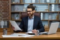 Mature successful financier working inside office at workplace with contracts and papers businessman behind paper work Royalty Free Stock Photo