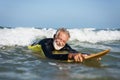 Mature surfer ready to catch a wave