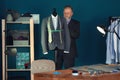 Mature tailor taking measurements of jacket on mannequin in atelier Royalty Free Stock Photo