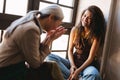 Mature teacher laughing and talking with her student during class