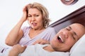 Mature tired girlfriend cannot stand guy snoring loudly Royalty Free Stock Photo