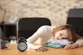 Mature tired woman sleeping at table in office. Time management concept Royalty Free Stock Photo