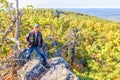 A mature male tourist stands on top of a mountain and admires the picturesque morning Ural view. Royalty Free Stock Photo