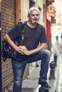 Mature tourist man with travel backpack in urban background. Royalty Free Stock Photo