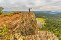 A mature male tourist stands on top of a mountain and admires the picturesque morning Ural view. Royalty Free Stock Photo