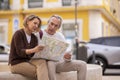 Mature Tourists Couple With Touristic Map Planning Holidays Sitting Outdoor Royalty Free Stock Photo