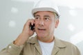 mature tradesman using telephone