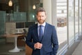 mature unshaven man entrepreneur in businesslike suit outside the office, agile business