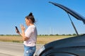 Mature upset woman driver calling on mobile phone for help, female near broken car Royalty Free Stock Photo