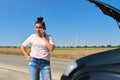Mature upset woman driver calling on mobile phone for help, female near broken car Royalty Free Stock Photo