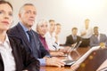 Mature white businessman sitting at meeting and listening to presentation Royalty Free Stock Photo