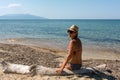 Mature woman, admiring the sea seating in a bathin Royalty Free Stock Photo