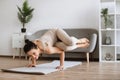 Mature woman in an advanced horizontal handstand yoga pose at home. Royalty Free Stock Photo